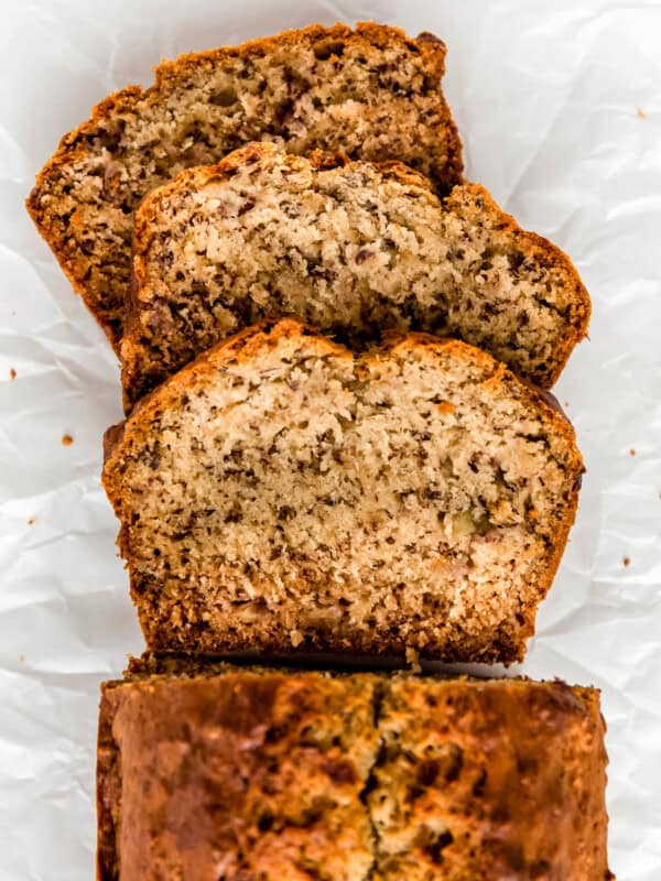 Slices of vegan banana bread on parchment paper