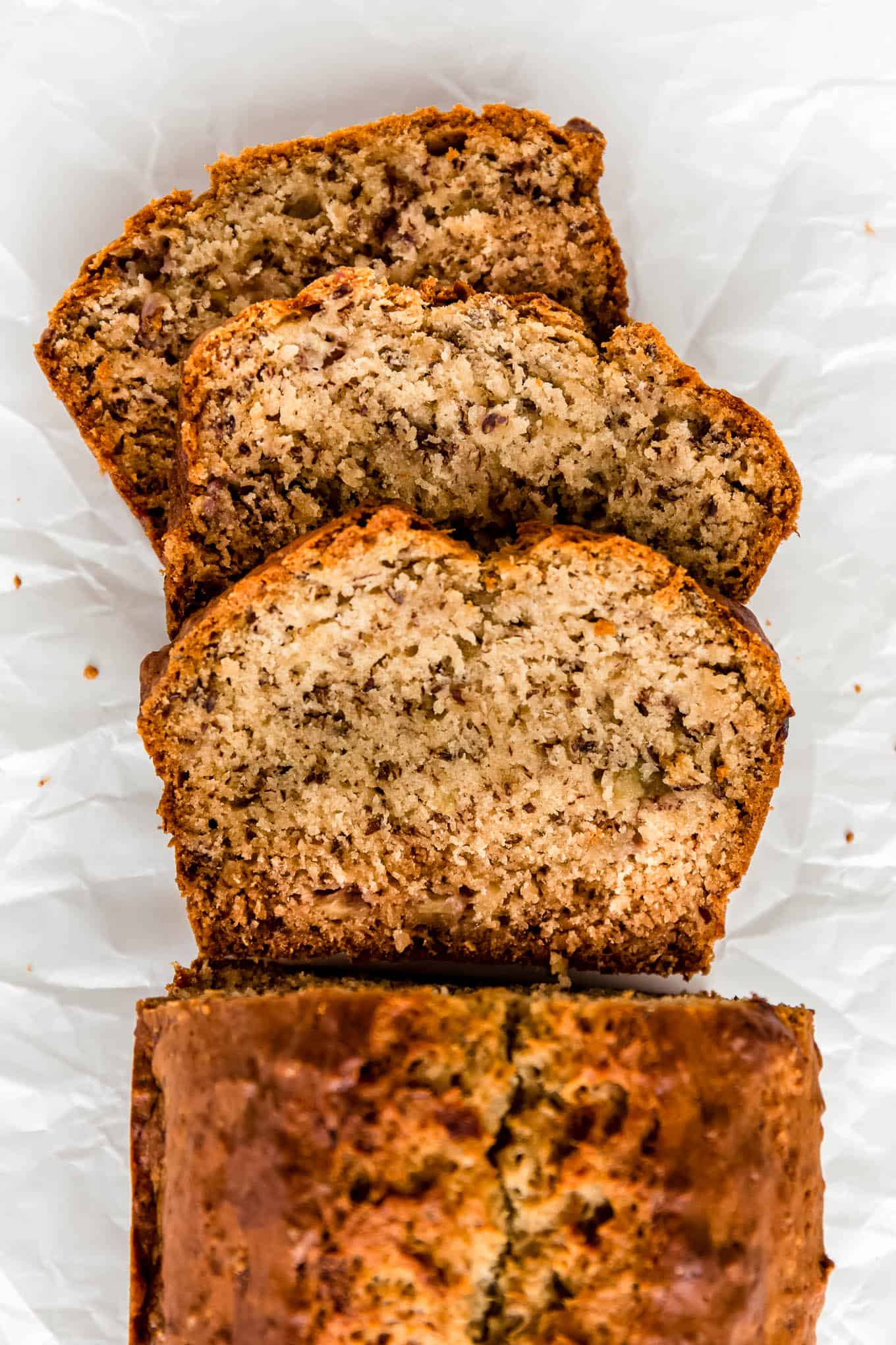 Slices of vegan banana bread on parchment paper