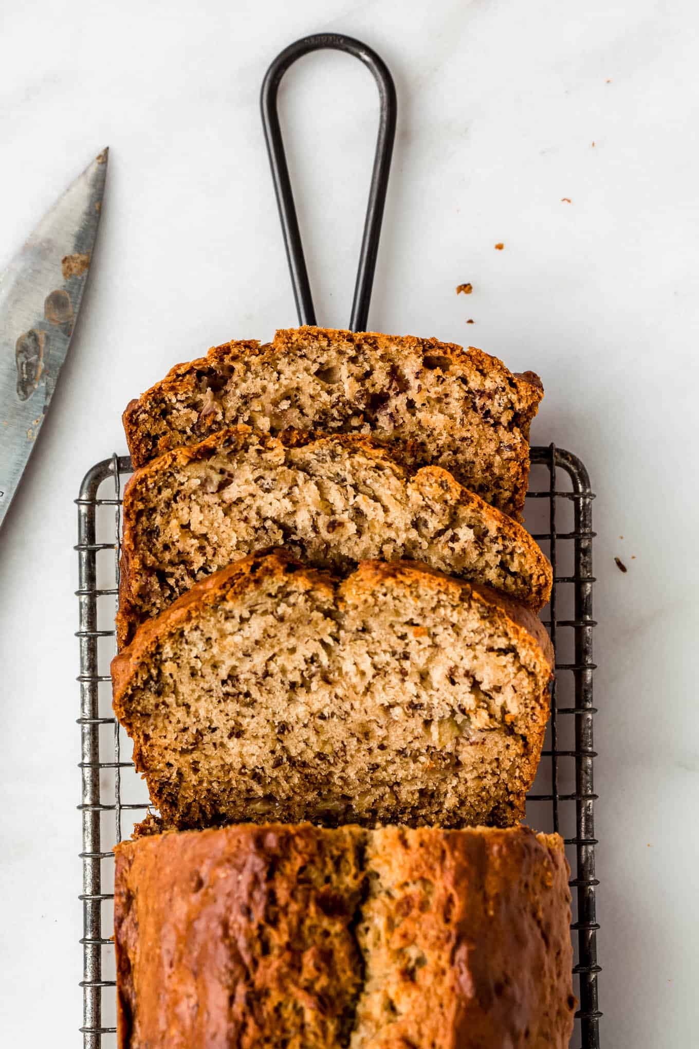 Sliced banana bread on a cooling rack