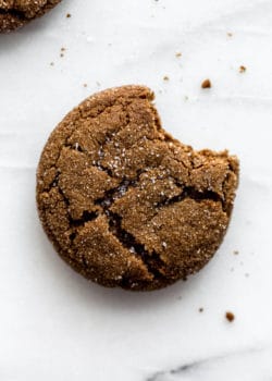 A ginger molasses cookie with a bite taken out of it