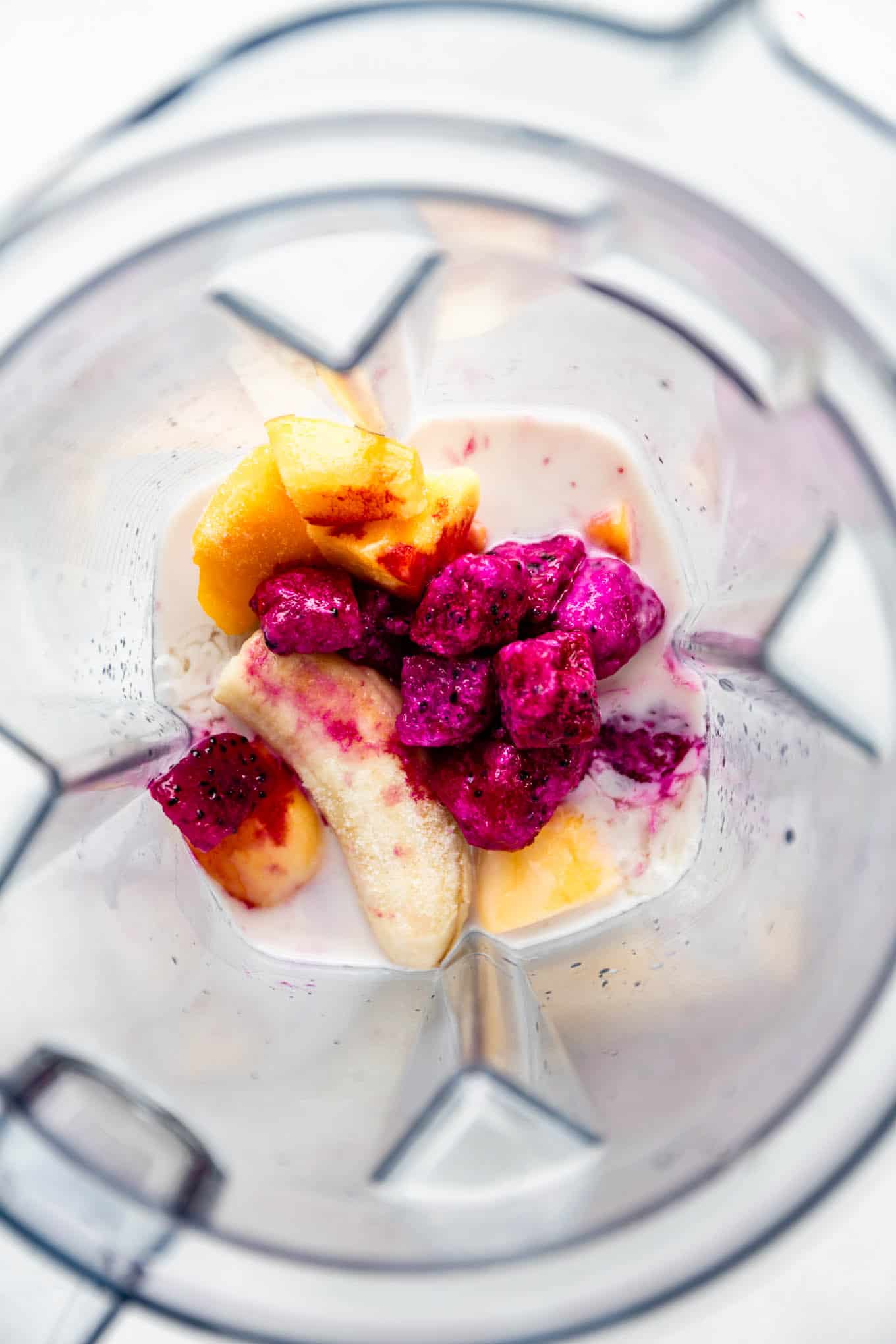 dragon fruit, mango, banana and coconut milk in a blender