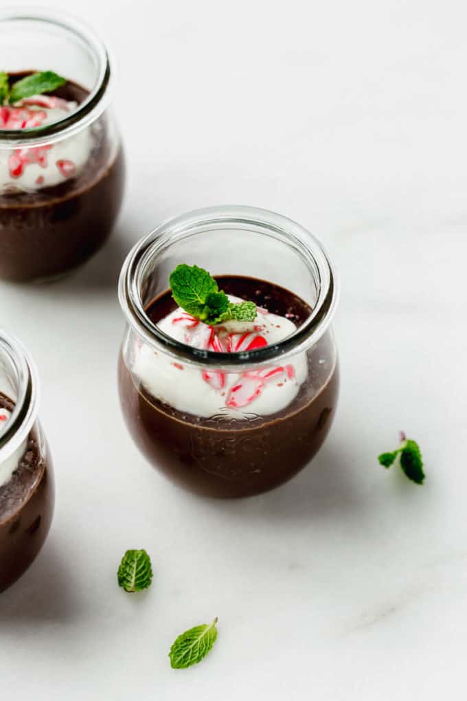 a cup of mint chocolate pudding topped with crushed candy canes