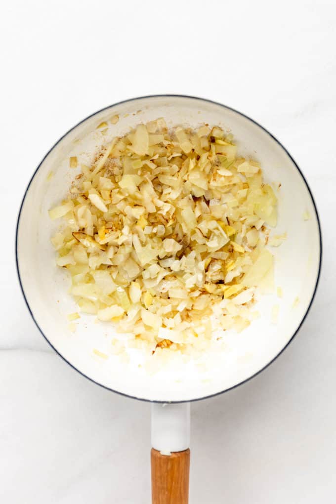 onions and garlic in a white pot