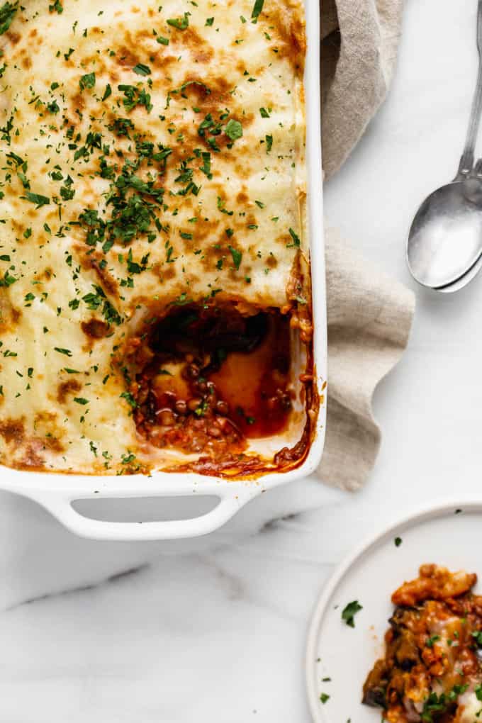Vegan moussaka with a scoop taken out of it on a plate