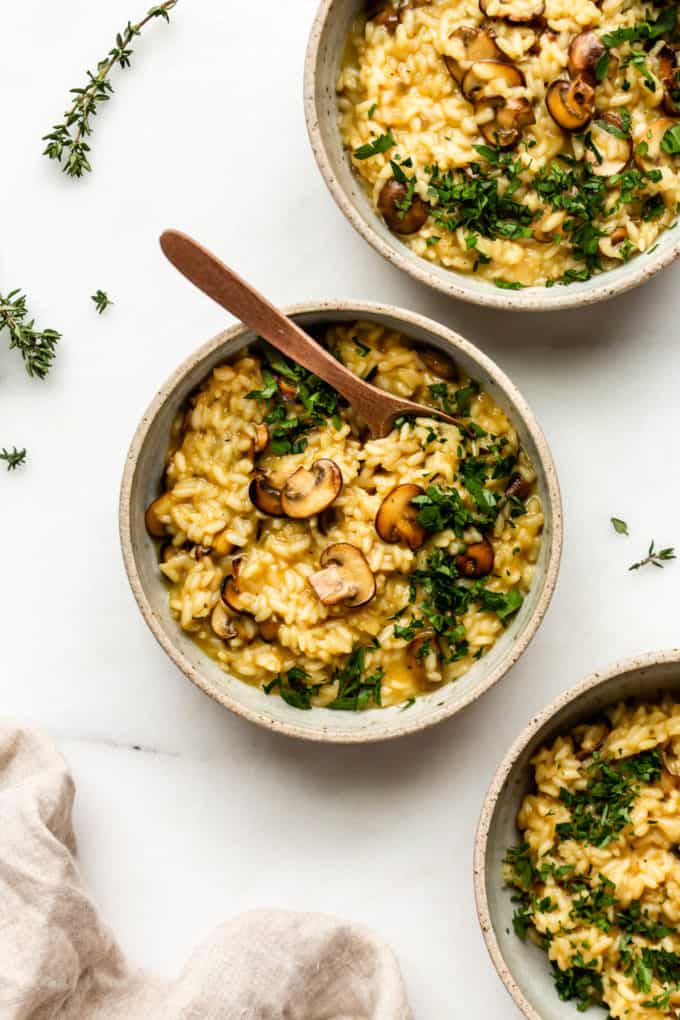 three bowls of vegan mushroom risotto