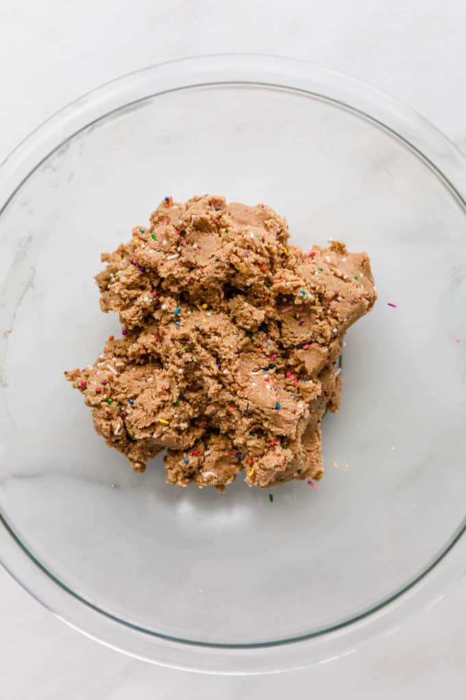 birthday cake protein balls dough in a mixing bowl