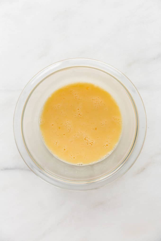eggs and almond milk mixed together in a mixing bowl