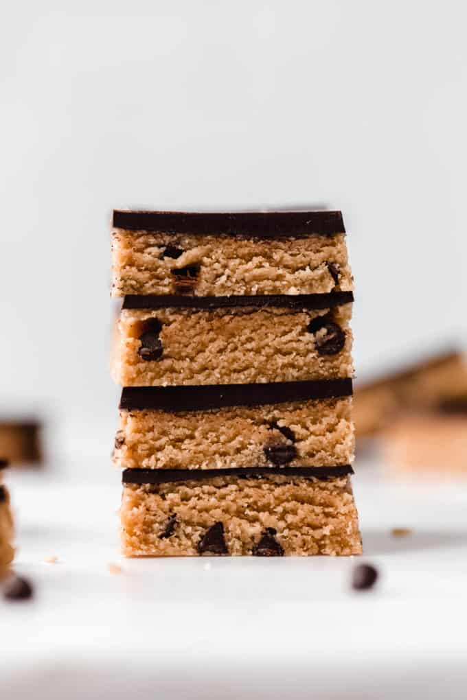 a stack of four no bake cookie dough bars