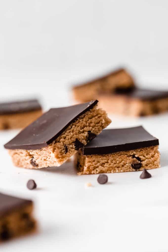 two no bake cookie dough bars with chocolate chips around them