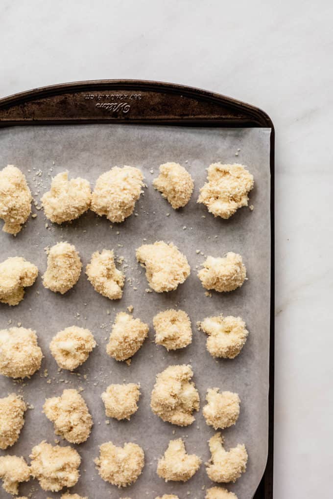 unbaked panko crusted cauliflower on a baking sheet