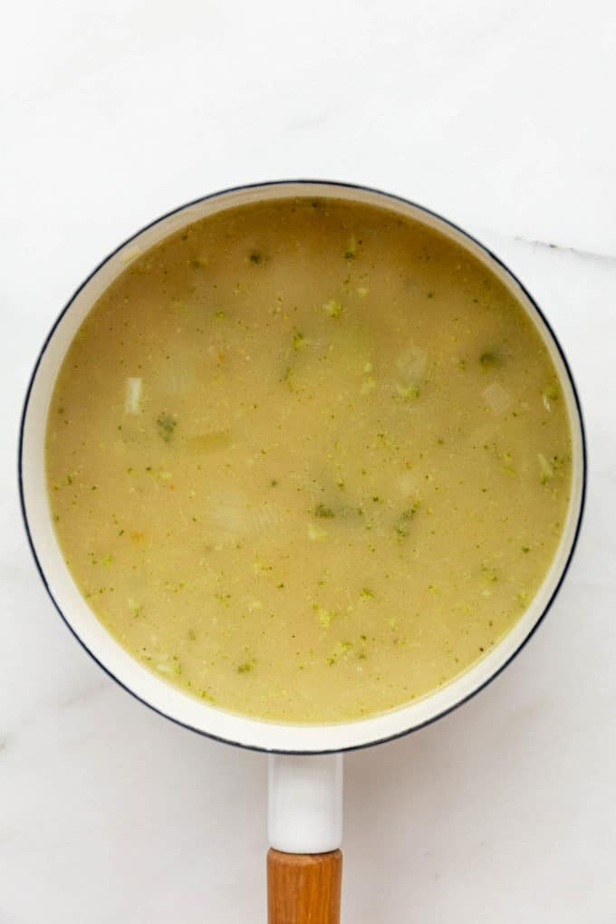 creamy vegan broccoli soup in a white pot