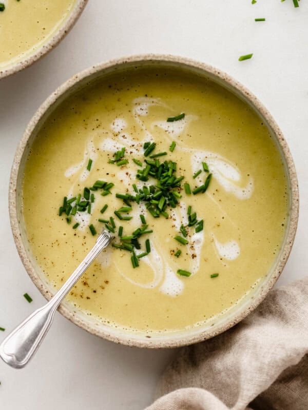 Blended creamy vegan broccoli soup in a ceramic bowl