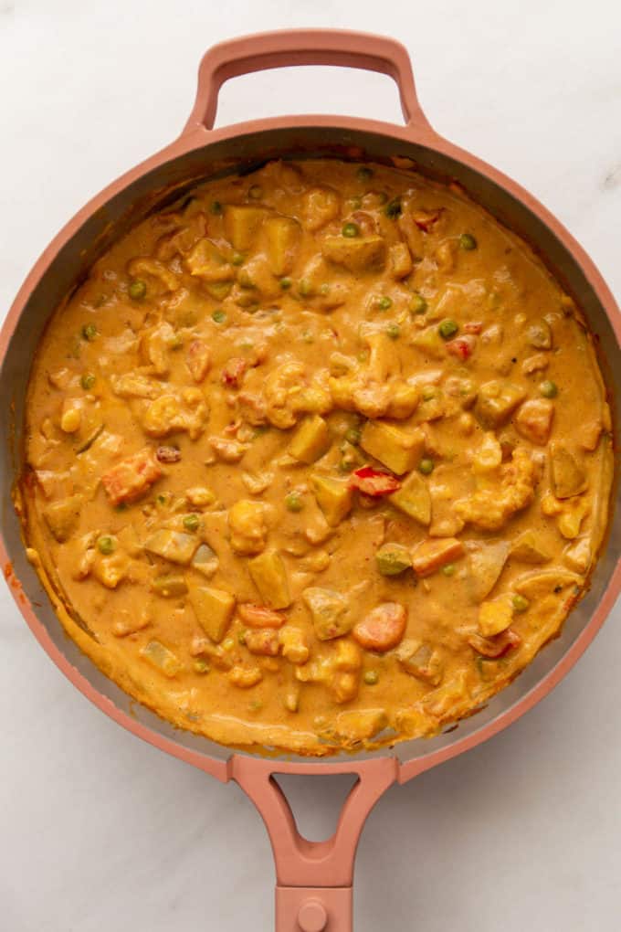 vegetable korma in a pink pan