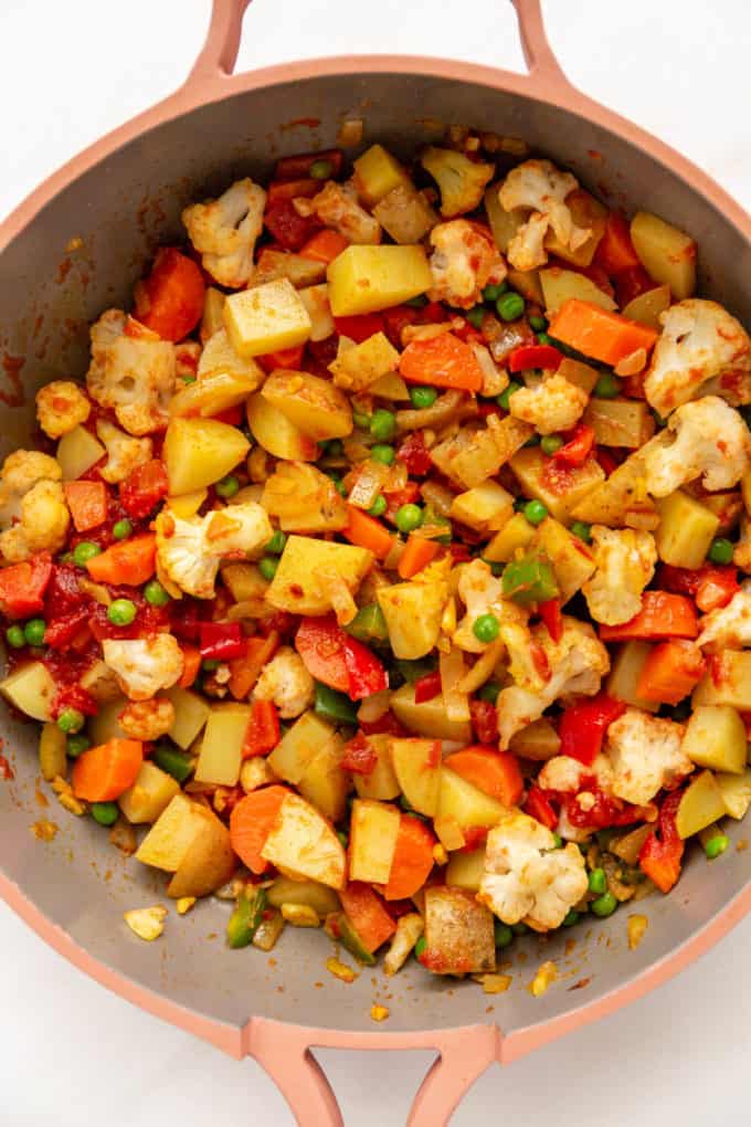 sauteéd vegetables in a pink pan