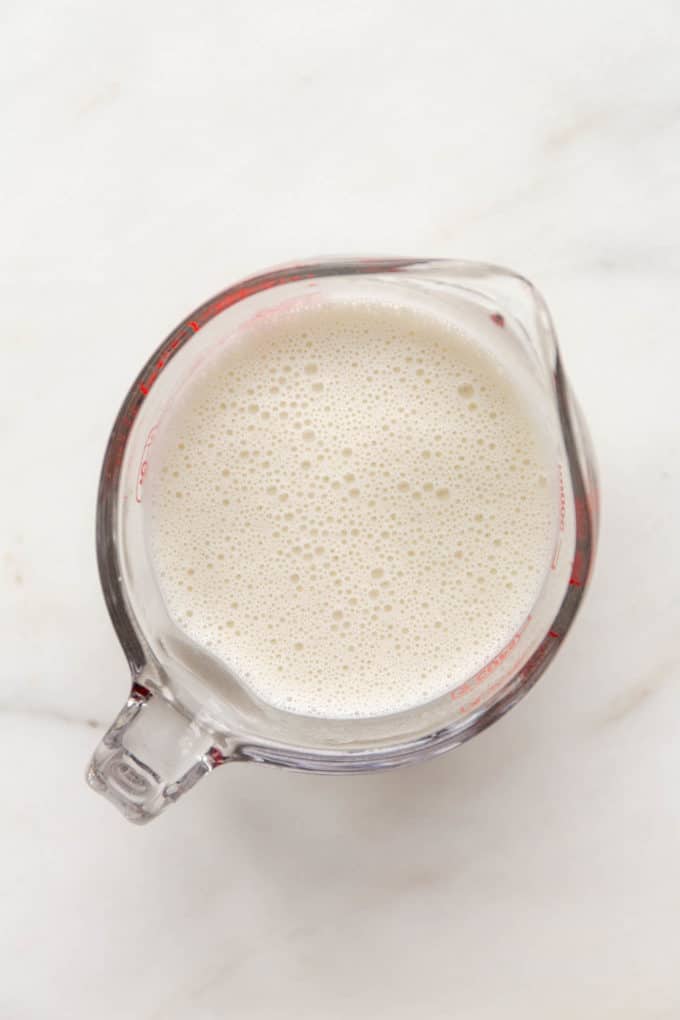 cashew cream in a measuring cup