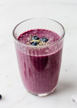 A blueberry spinach smoothie in a glass