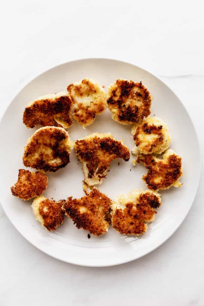 Panko crusted cauliflower on a white plate