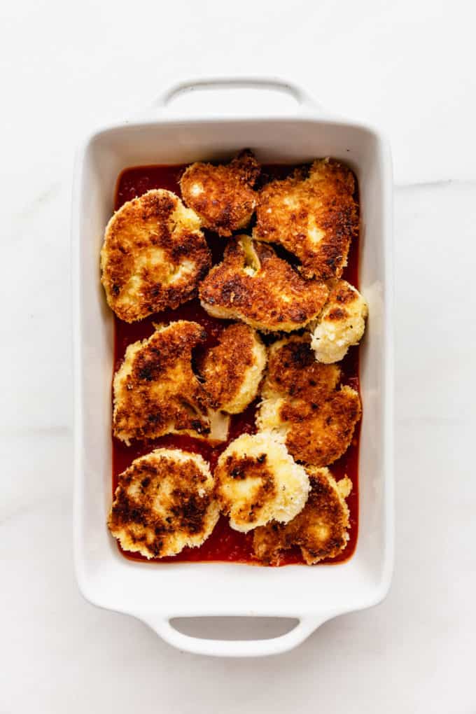 Panko crusted cauliflower in a white baking dish