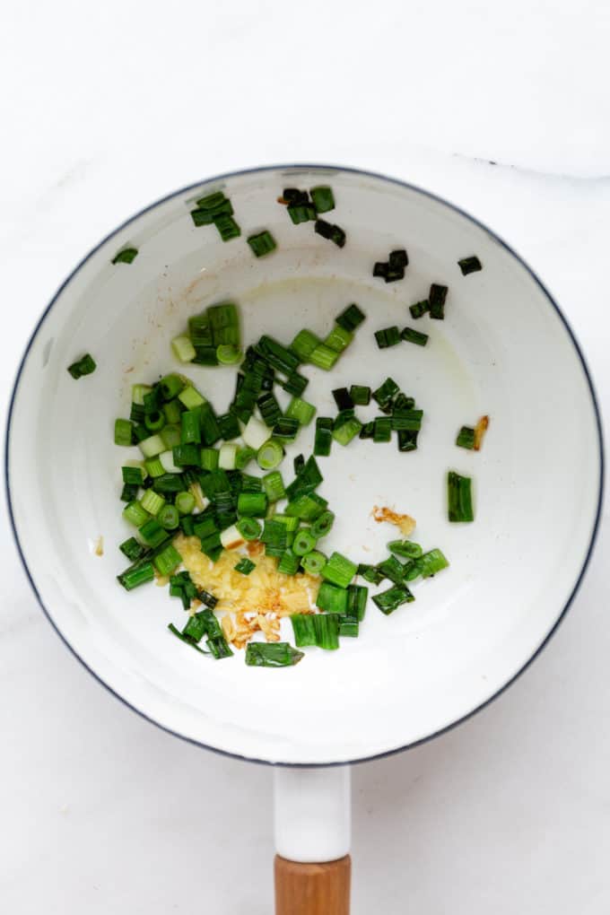 scallions and ginger in a white pot