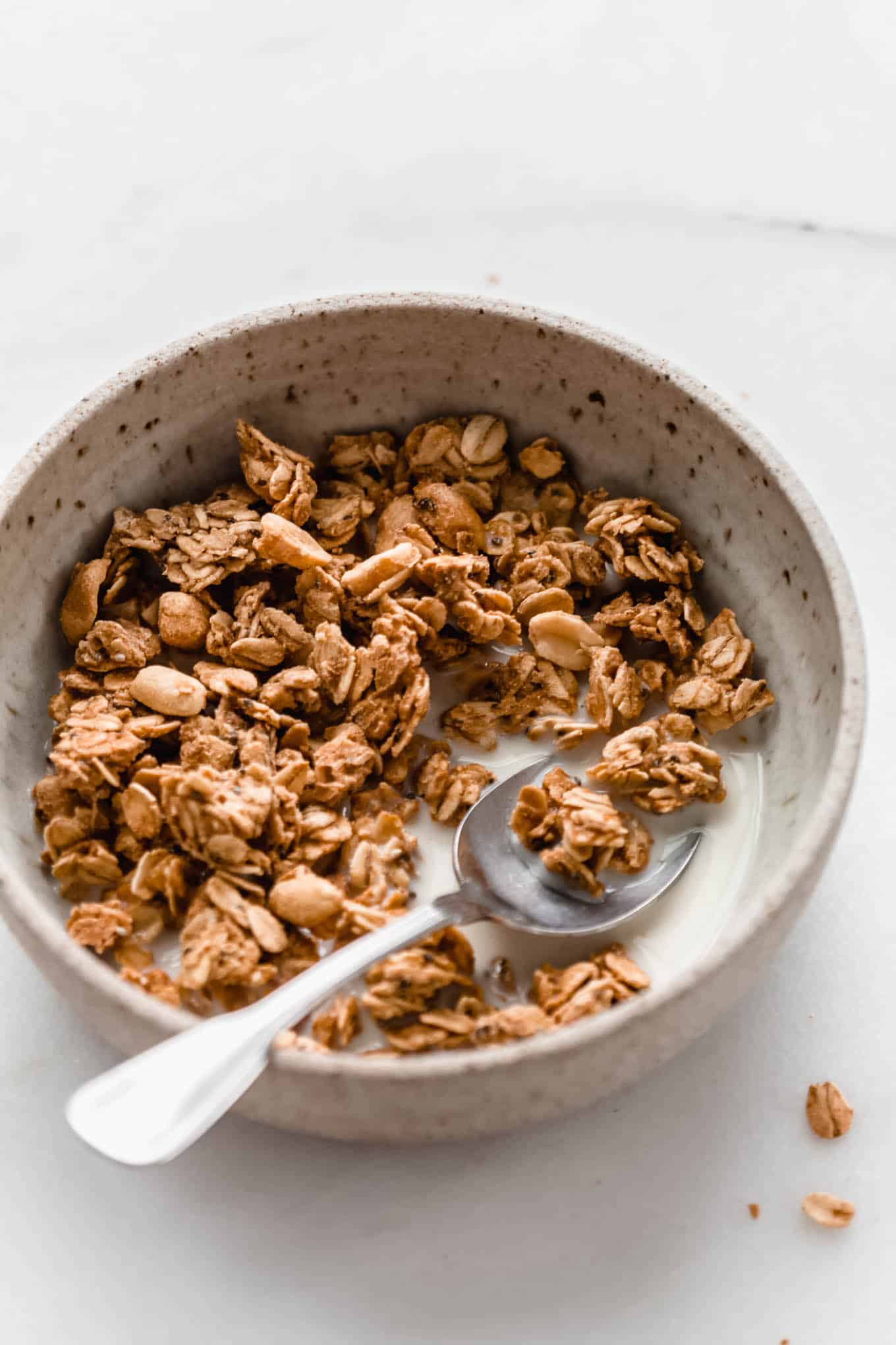 peanut butter granola in a speckled ceramic bowl
