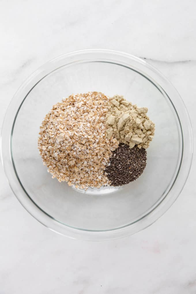 oats, protein powder and chia seeds in a mixing bowl.