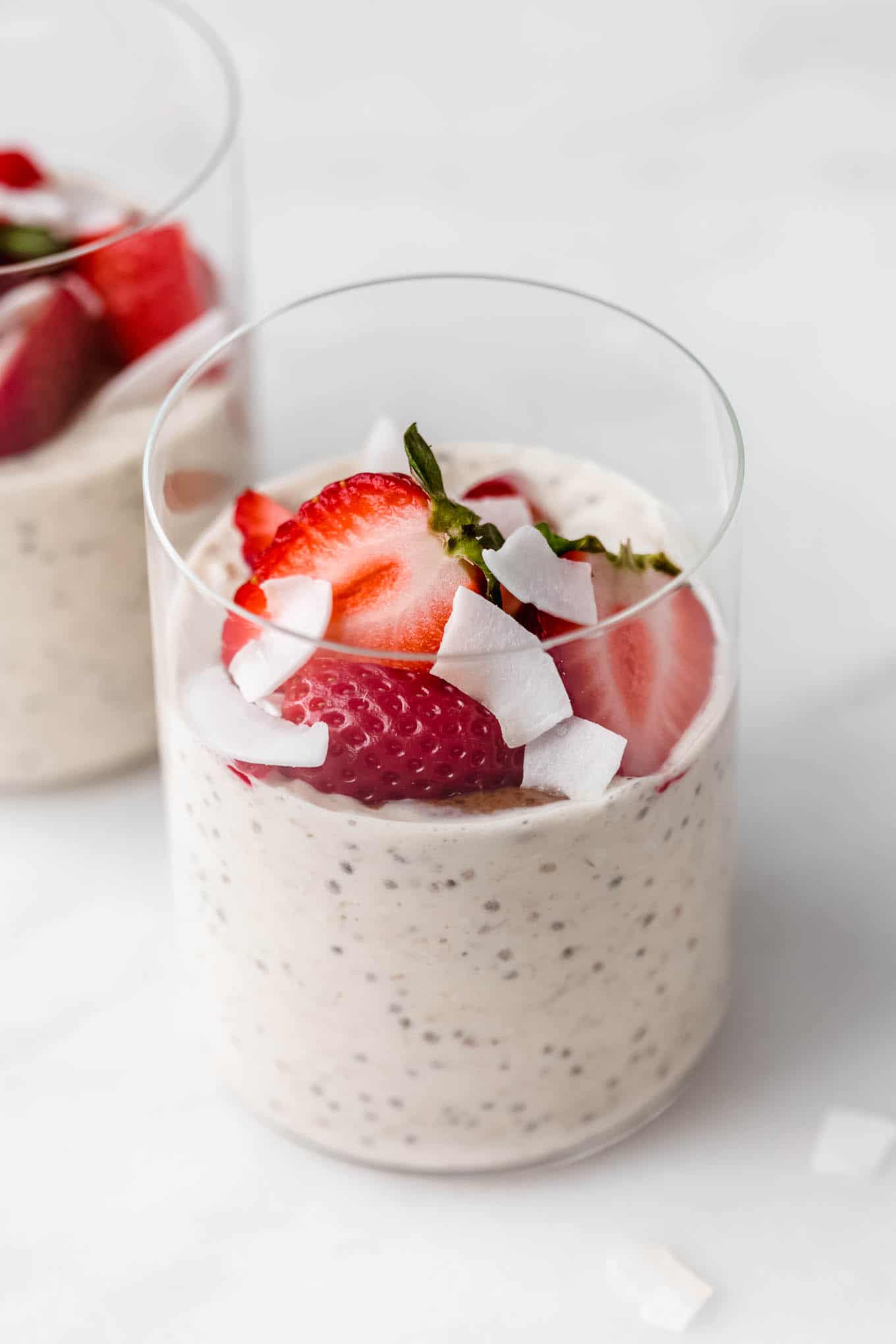a cup of protein overnight oats topped with strawberries