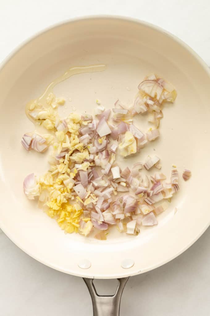 onion, garlic and ginger in a white pan