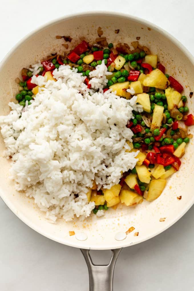 pineapple, vegetables and rice in a white pan