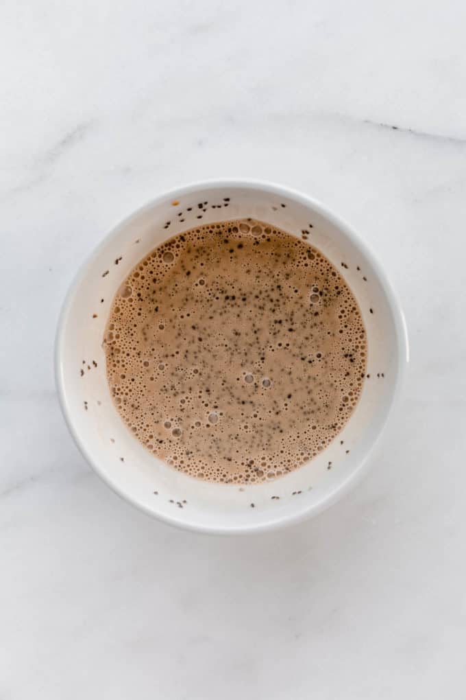 coconut milk with coffee and chia seeds in a white bowl