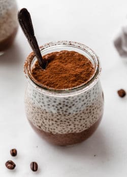 layered tiramisu chia pudding with a spoon in it