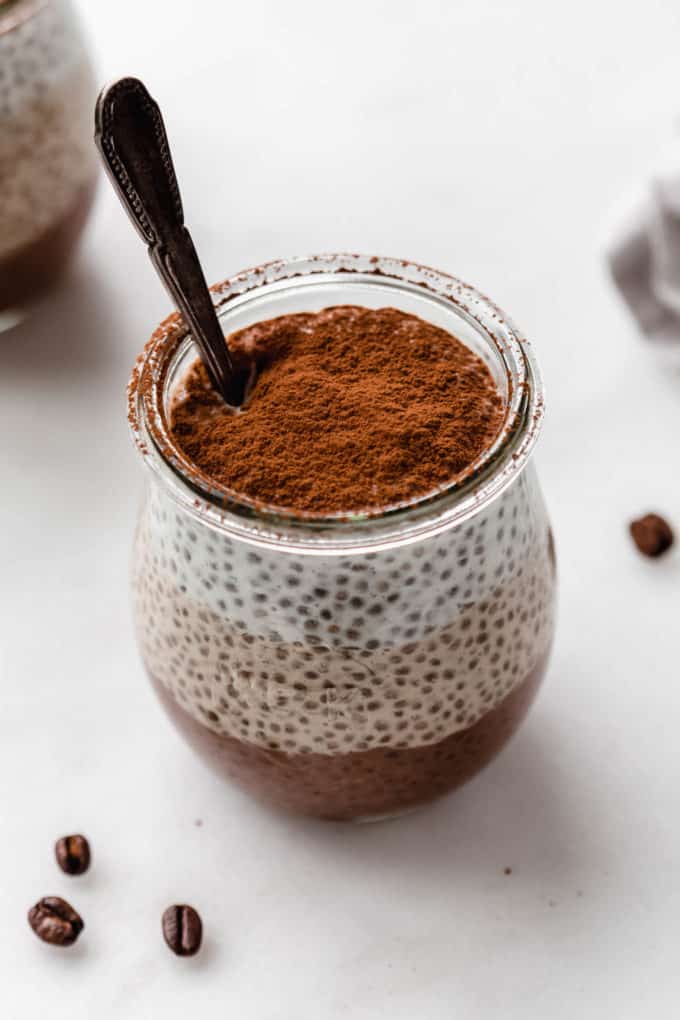 layered tiramisu chia pudding with a spoon in it