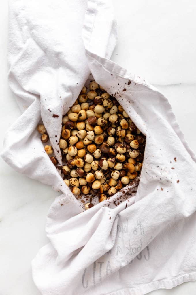 hazelnuts with skins removed in a white dish towel