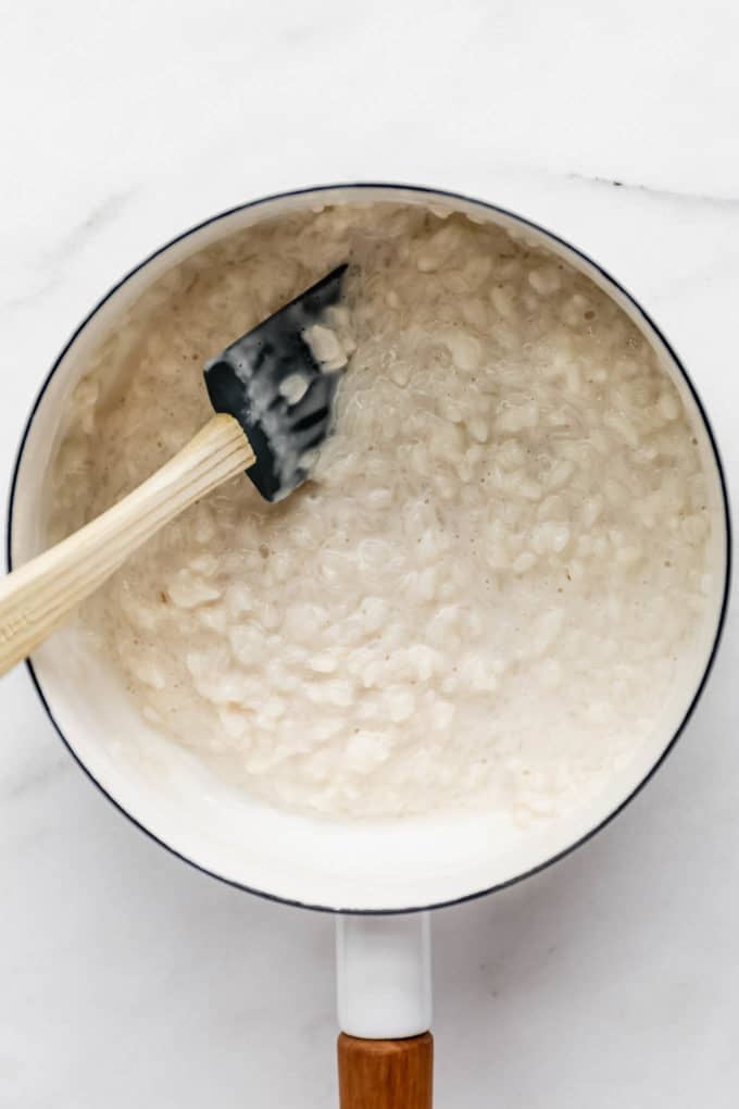 creamy rice in a pot of coconut milk