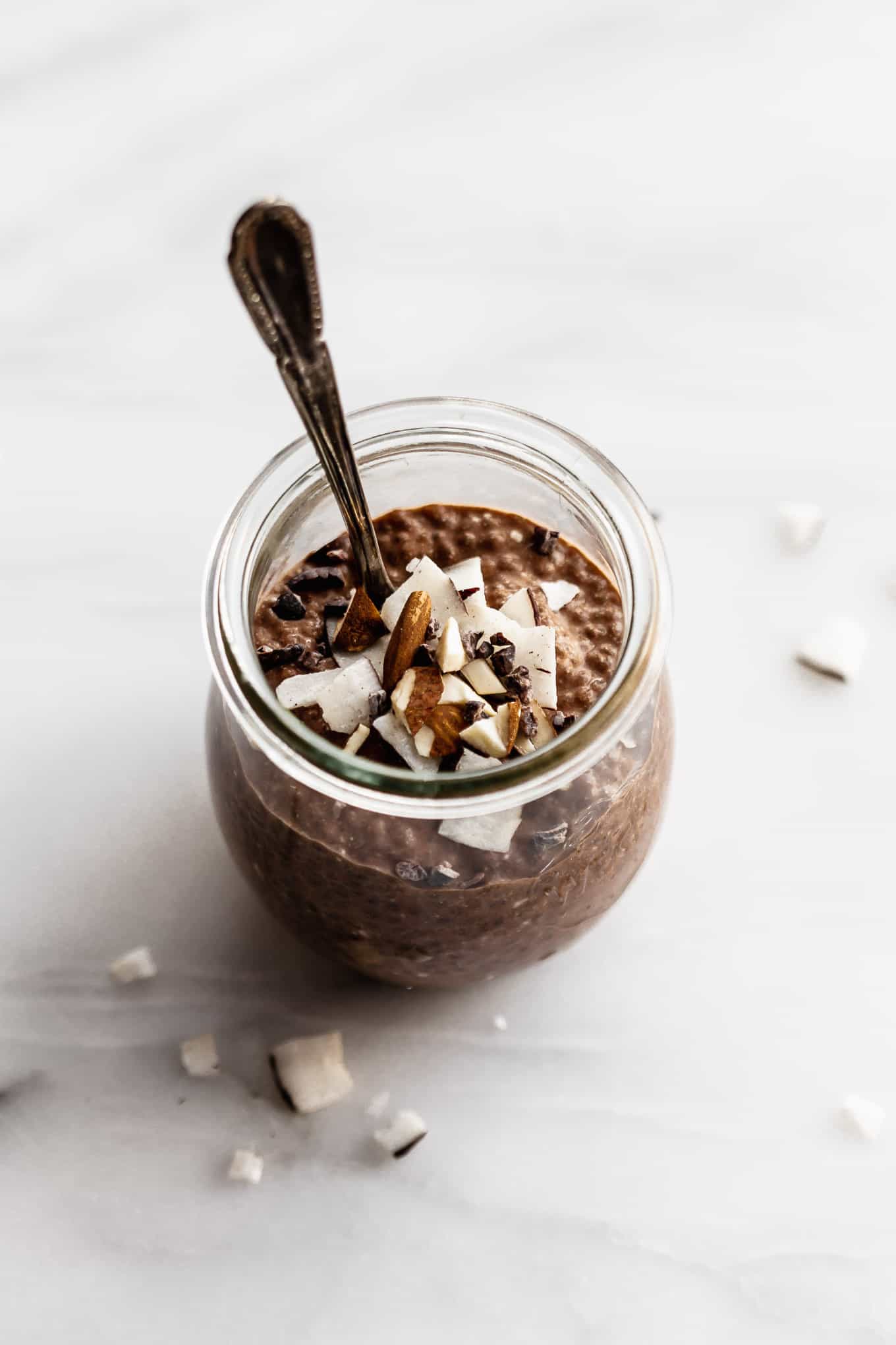 a cup of chocolate chip pudding with a spoon in it