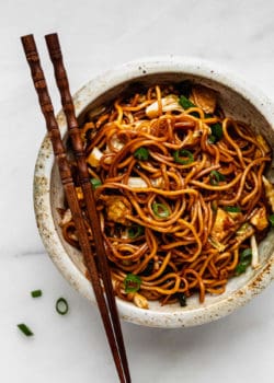A bowl of mie goreng noodles with chopsticks