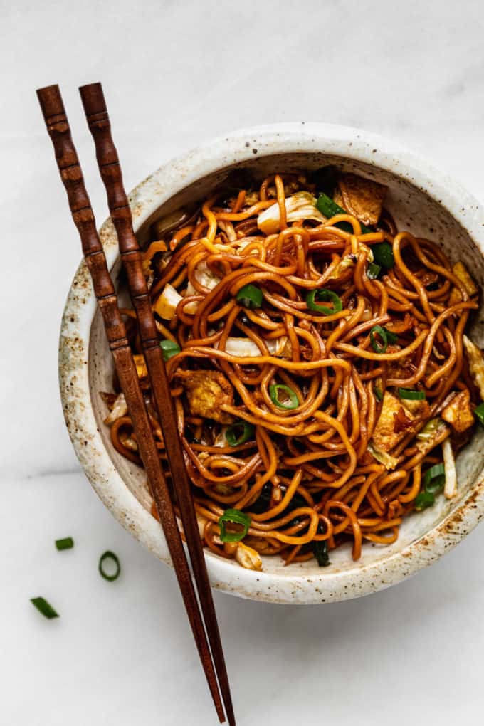 A bowl of mie goreng noodles with chopsticks