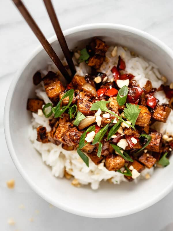 a bowl of kung pao tofu topped with green onions