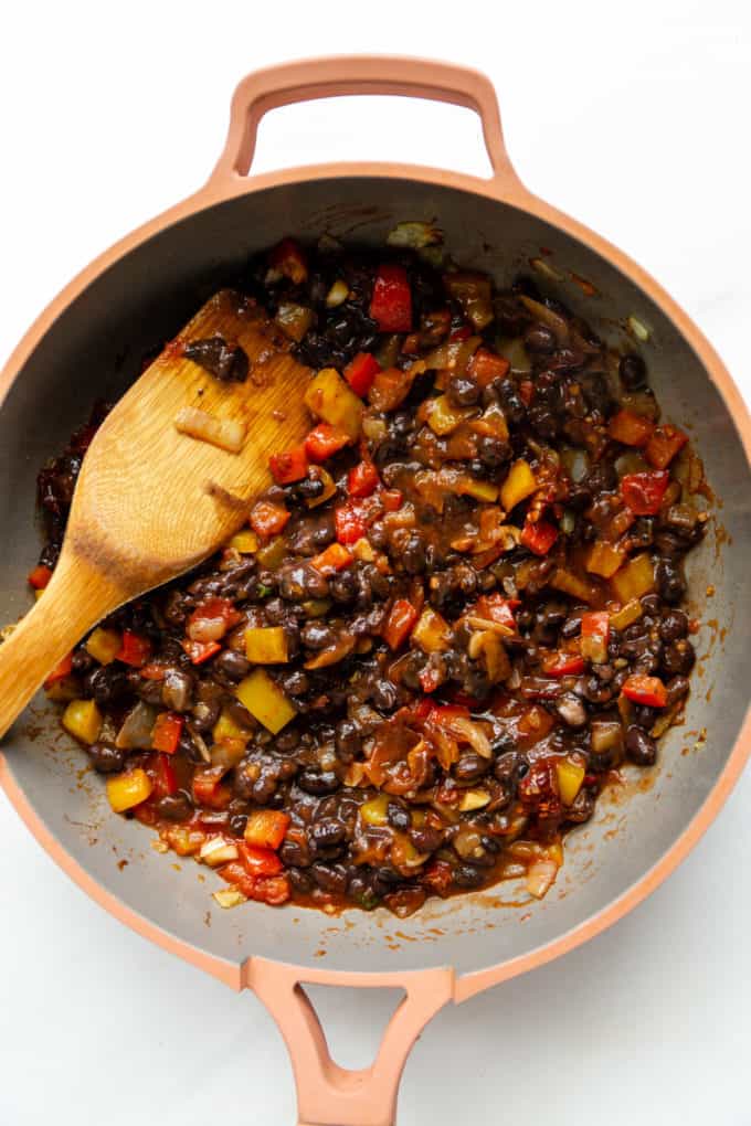 beans with chipotle and peppers in a pink pan