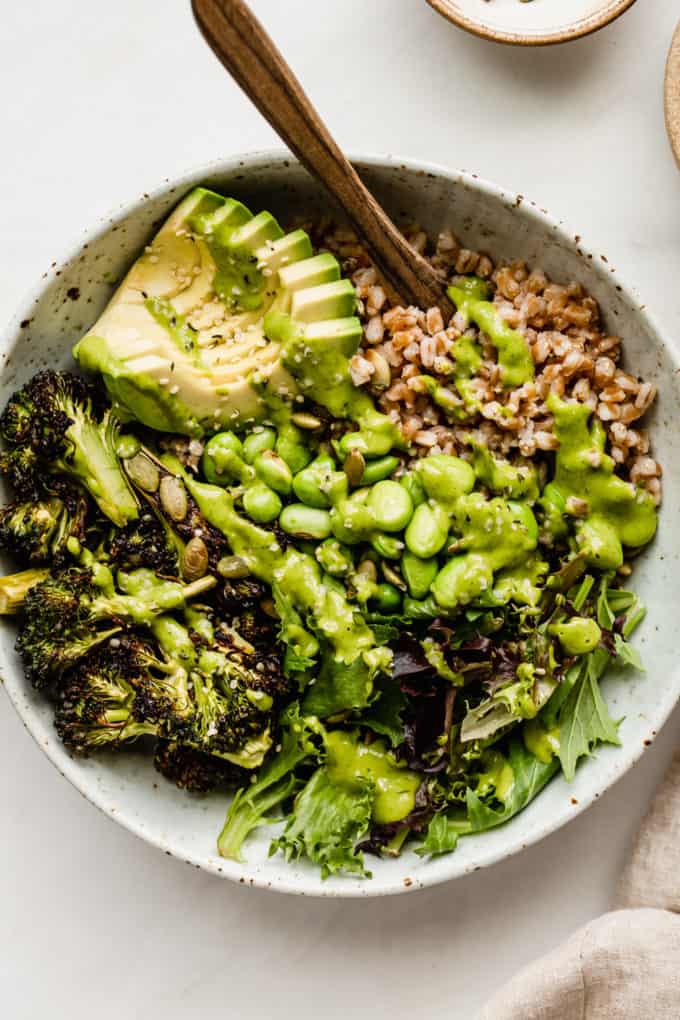A green goddess bowl topped with green goddess dressing