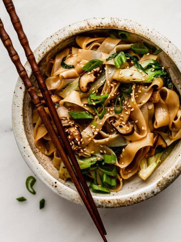 ho fun noodles in a bowl with wood chop sticks
