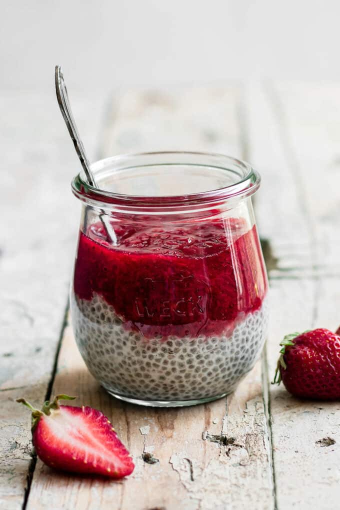 a cup of strawberry rhubarb chia pudding with a spoon in it