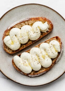 whipped ricotta with olive oil and pepper on two slices of toast
