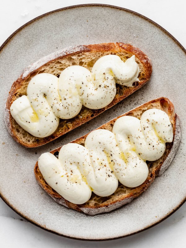 whipped ricotta with olive oil and pepper on two slices of toast