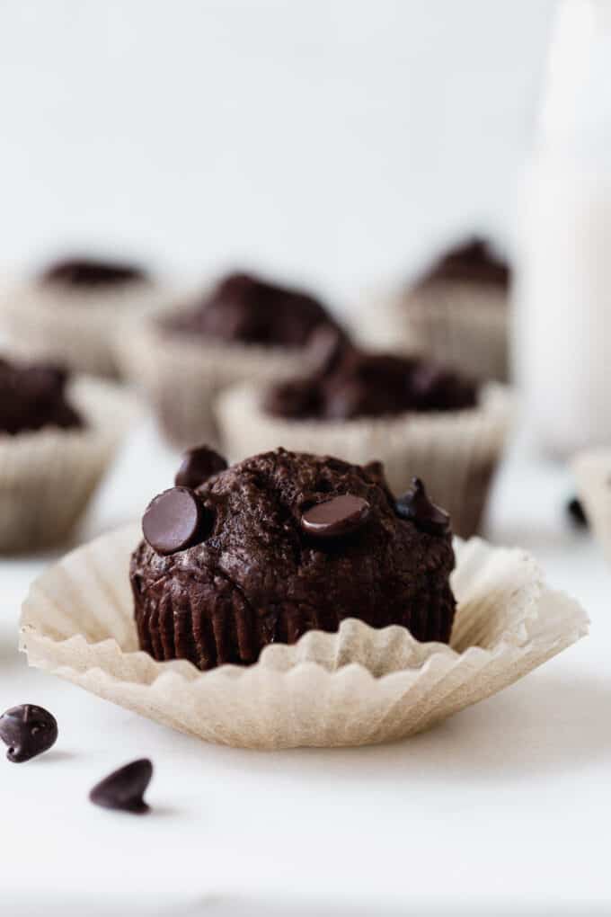 a chocolate zucchini muffin in a muffin liner