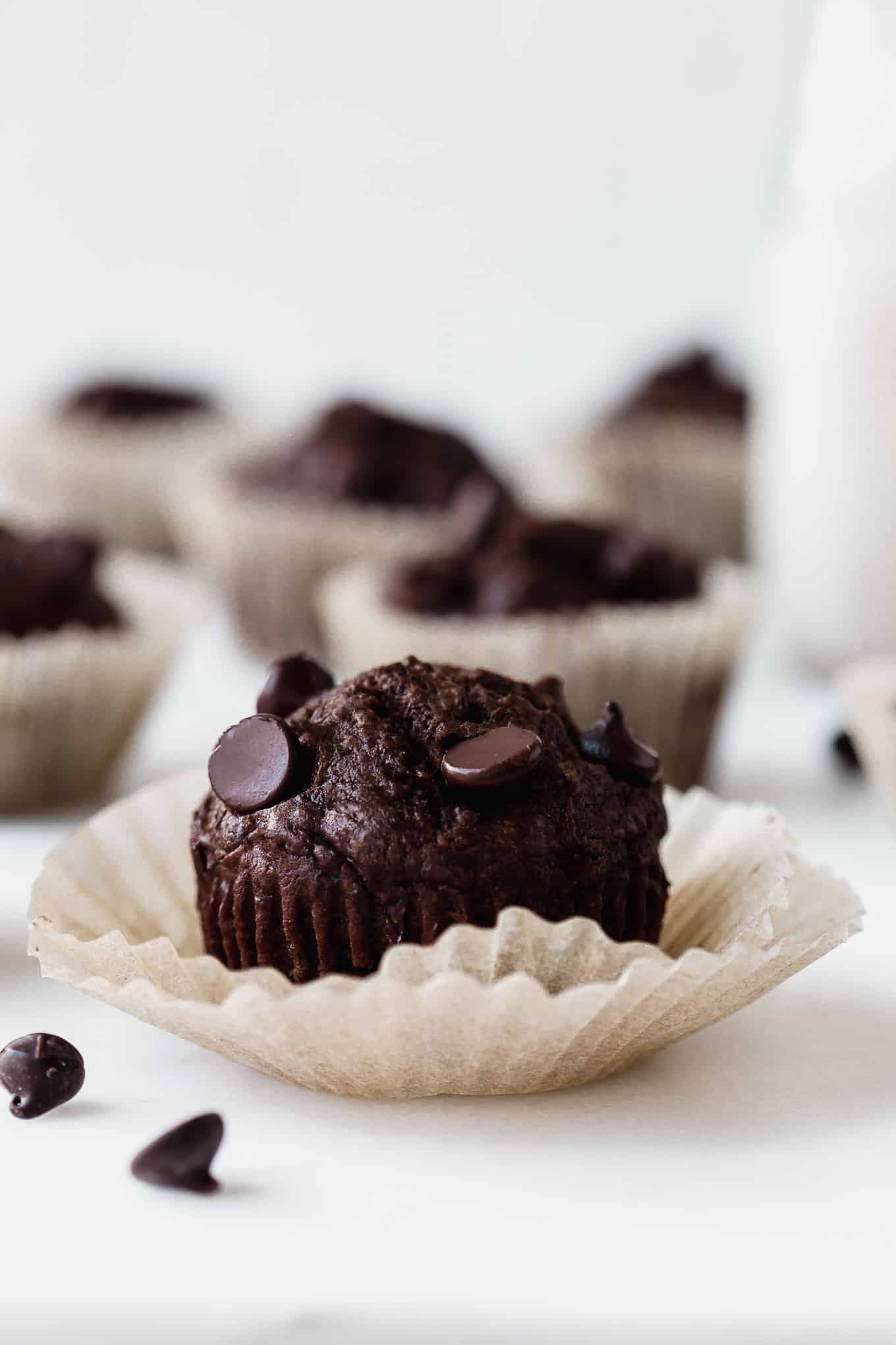 a chocolate zucchini muffin in a muffin liner