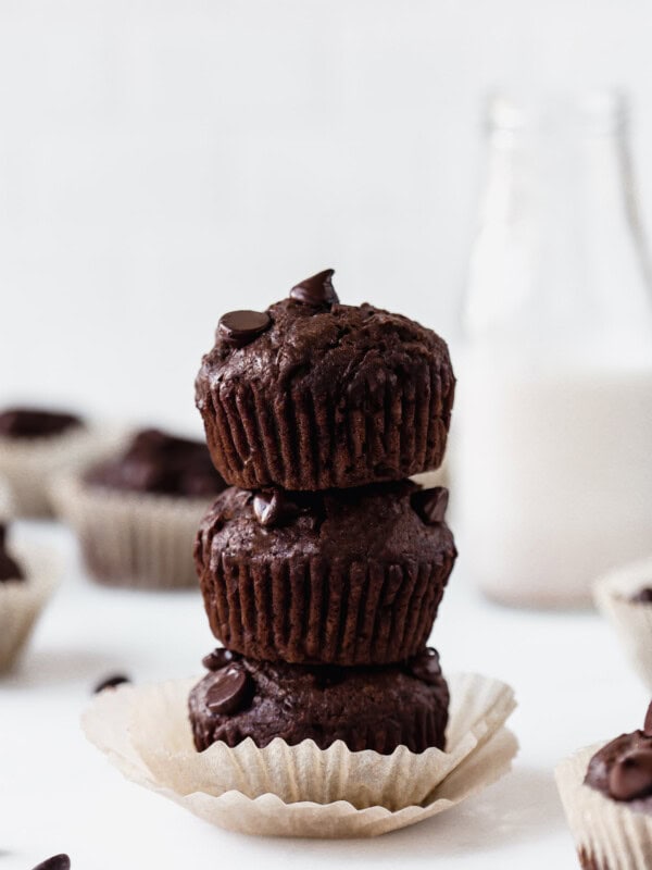 three chocolate zucchini muffins stacked