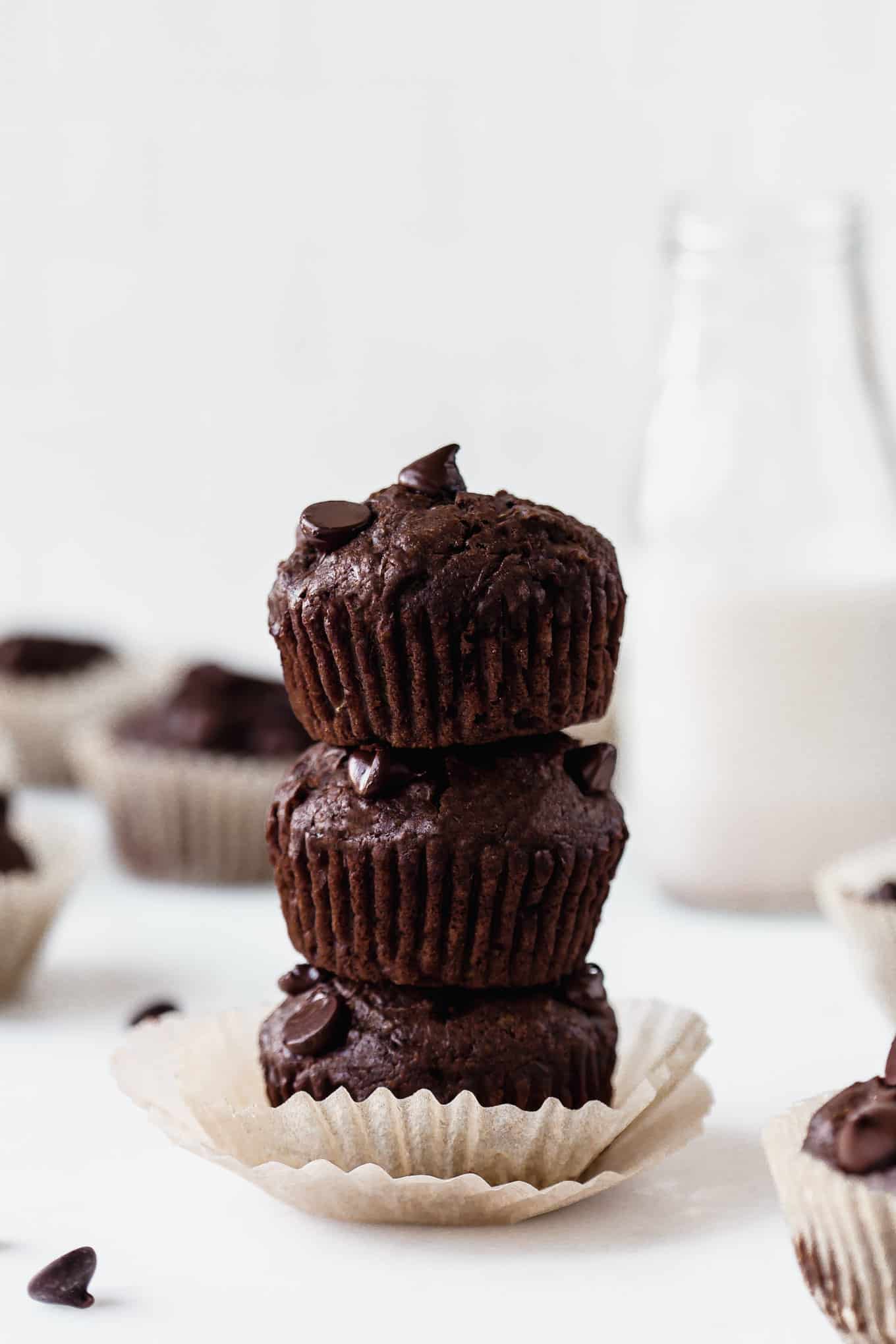 three chocolate zucchini muffins stacked