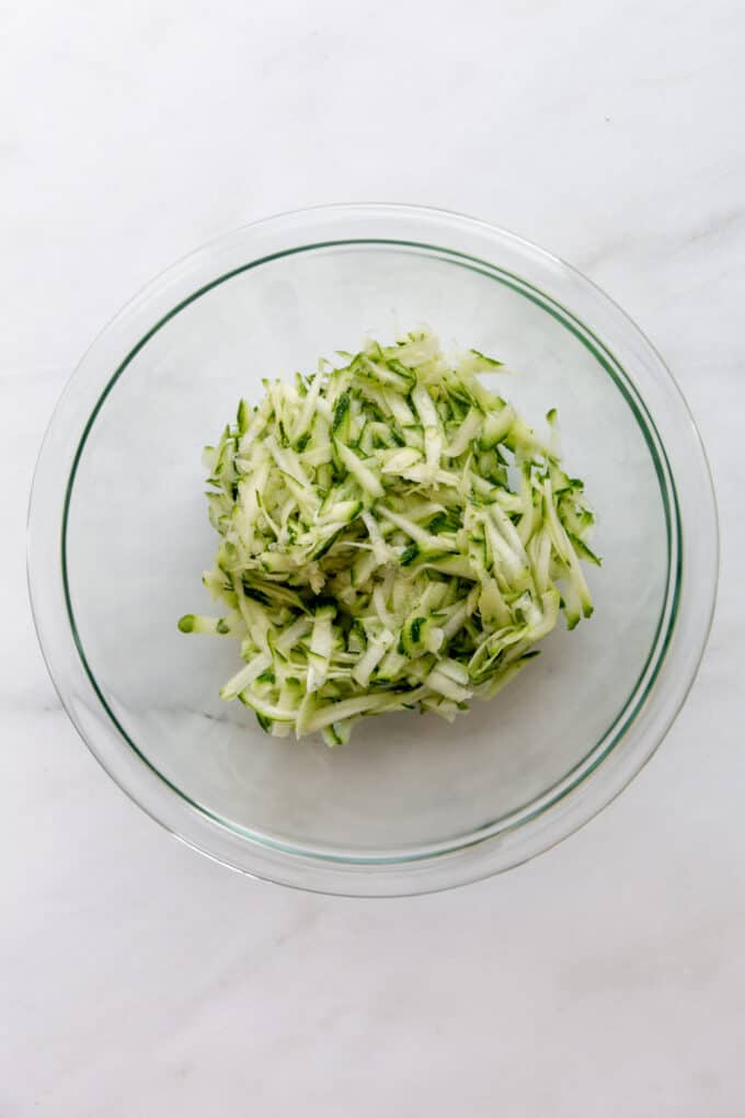 shredded zucchini in a clear bowl