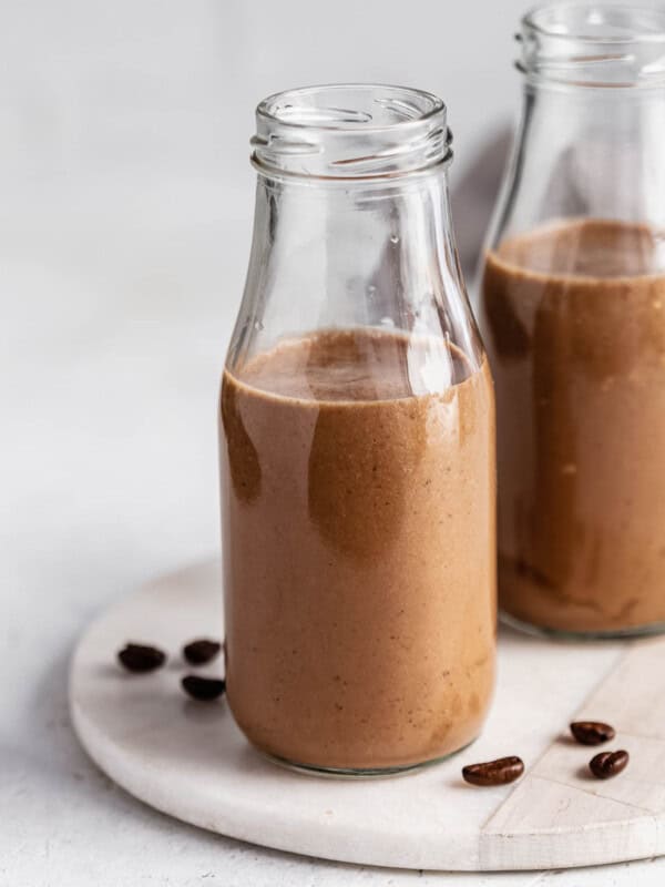 Two jars of coffee smoothie on a marble tray
