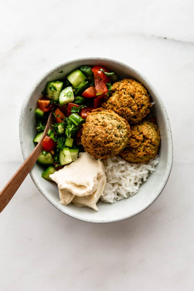 falafel, salad, rice and hummus in a bowl